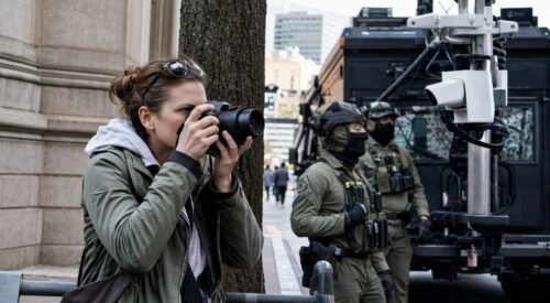 Here's a sentence that should stop you cold: a woman stood on a public sidewalk in Portland, Maine, took a photo of federal agents making an arrest, and within days her spouse's home address, phone number, and a list of everyone living in that house